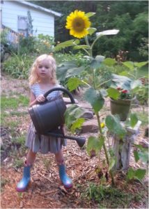 Girl holding flower pot.