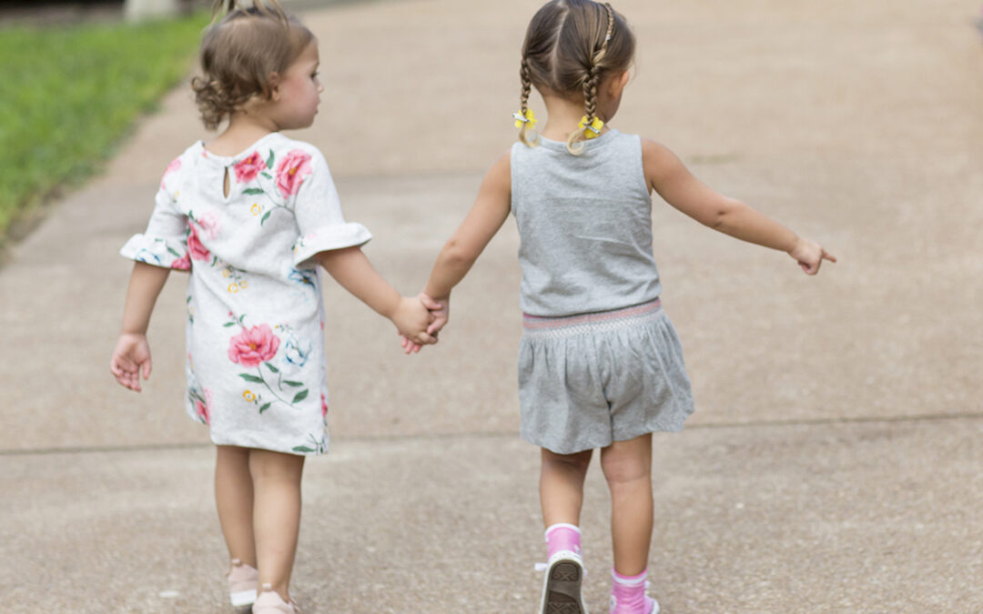 Young girls holding hands